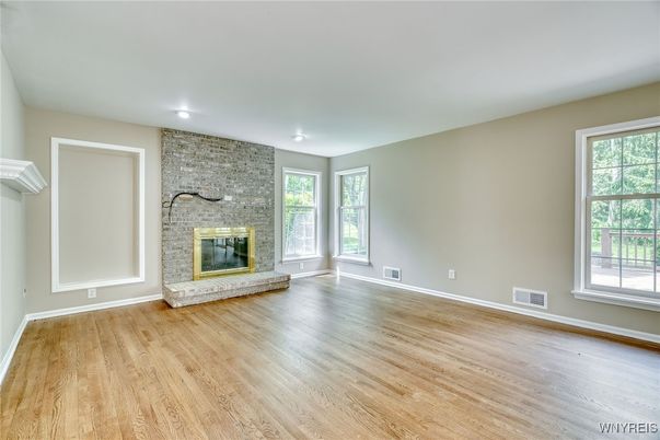 Empty room, Fireplace, Interior, Recessed Lighting, Stone Walls, Wood Texture Flooring