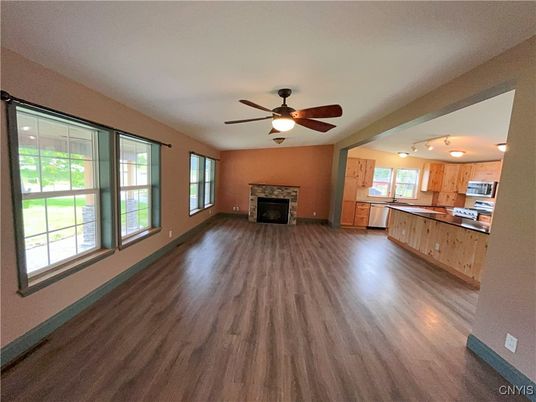 Empty room, Fireplace, Interior, Kitchen, Stainless Steel Appliances, Wood Texture Flooring