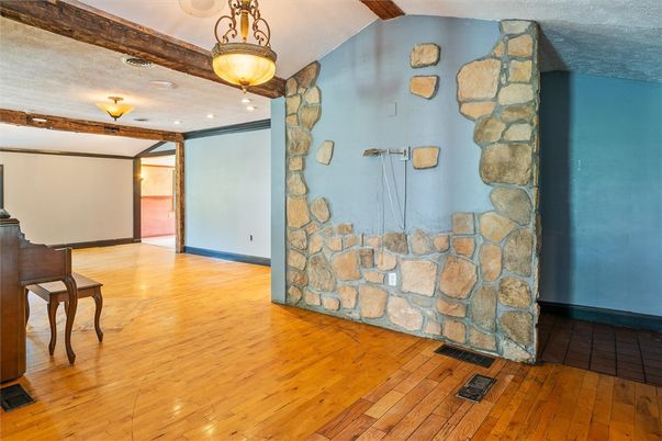Empty room, Fireplace, Interior, Pendant Lights, Piano, Recessed Lighting, Stone Walls, Wood Texture Flooring