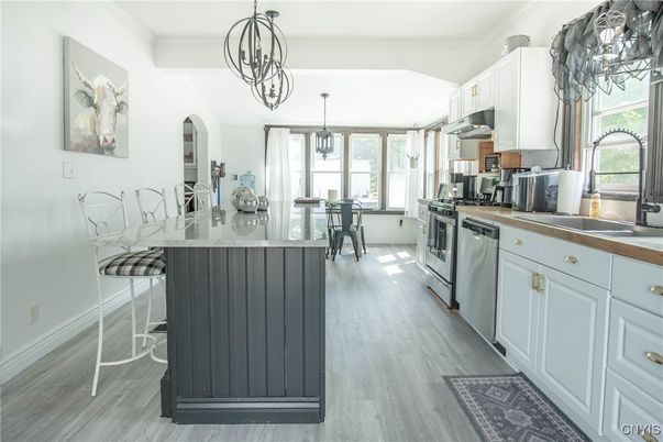 Chandelier, Dining room, Interior, Kitchen, Pendant Lights, Stainless Steel Appliances, Wood Texture Flooring