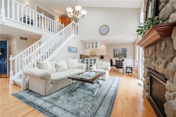Chandelier, Fireplace, Interior, Living room, Recessed Lighting, Stone Walls, Wood Texture Flooring