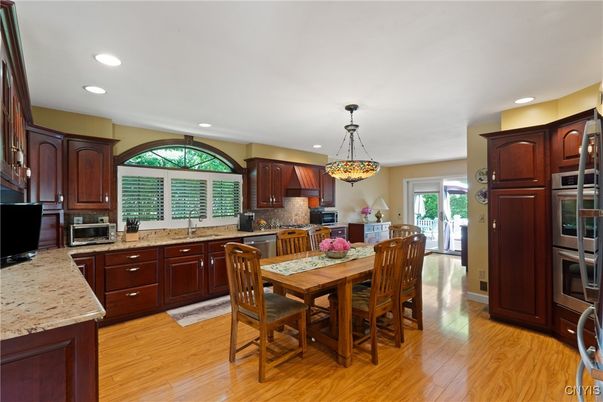 Dining room, Interior, Kitchen, Pendant Lights, Recessed Lighting, Stainless Steel Appliances, Wood Texture Flooring