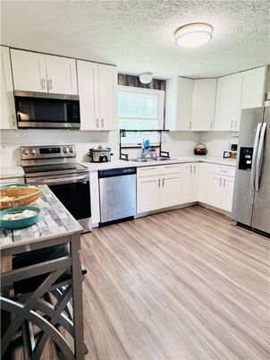Interior, Kitchen, Stainless Steel Appliances, Tile Countertops, Wood Texture Flooring