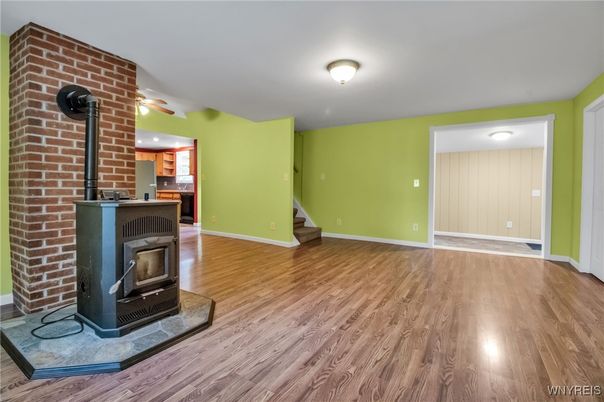 Empty room, Fireplace, Interior, Recessed Lighting, Stone Walls, Wood Texture Flooring