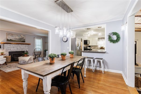 Dining room, Fireplace, Interior, Kitchen, Pendant Lights, Stainless Steel Appliances, Wood Texture Flooring