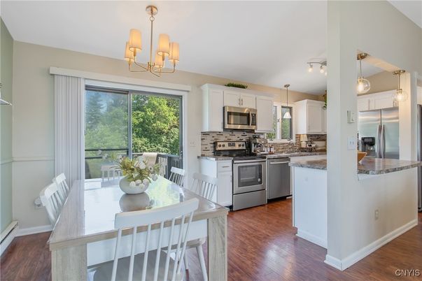 Chandelier, Dining room, Interior, Kitchen, Pendant Lights, Stainless Steel Appliances, Wood Texture Flooring