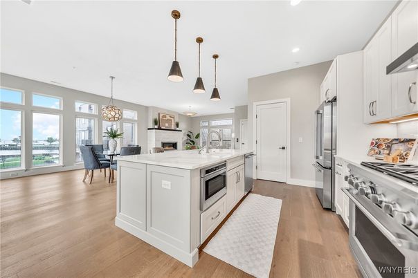Chandelier, Dining room, Interior, Kitchen, Pendant Lights, Recessed Lighting, Stainless Steel Appliances, Wood Texture Flooring