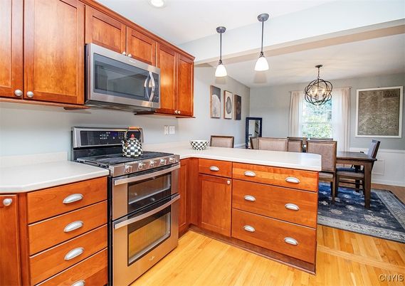 Chandelier, Dining room, Interior, Kitchen, Pendant Lights, Recessed Lighting, Stainless Steel Appliances, Wood Texture Flooring