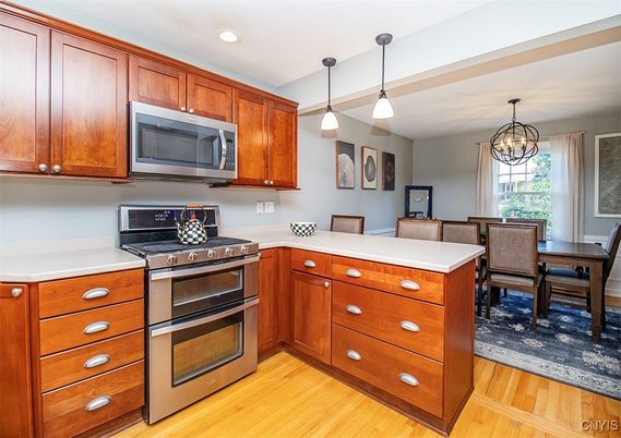 Chandelier, Dining room, Interior, Kitchen, Pendant Lights, Recessed Lighting, Stainless Steel Appliances, Wood Texture Flooring