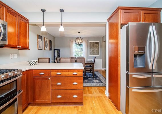 Chandelier, Dining room, Interior, Kitchen, Pendant Lights, Stainless Steel Appliances, Wood Texture Flooring