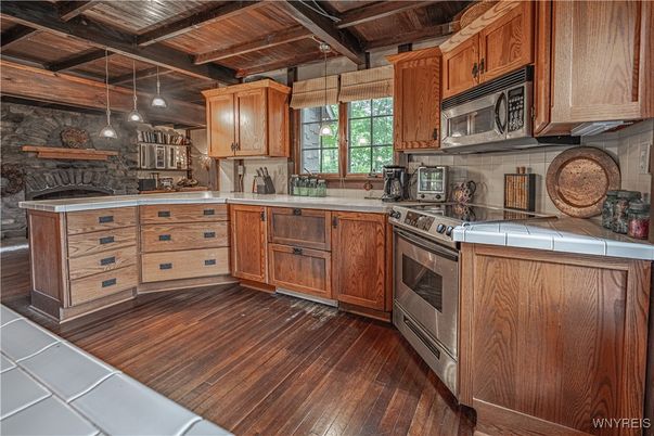 Fireplace, Interior, Kitchen, Pendant Lights, Stone Walls, Tile Countertops, Wooden Beams, Wooden Ceilings, Wood Texture Flooring