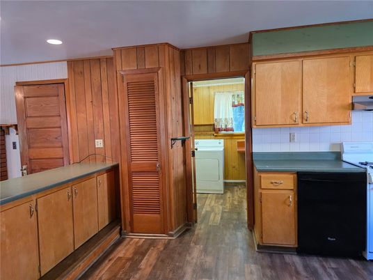Interior, Kitchen, Recessed Lighting, Washer, Wood Texture Flooring, Wooden Walls
