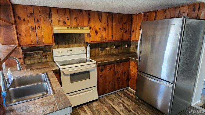 Interior, Kitchen, Tile Countertops, Wood Texture Flooring, Wooden Walls