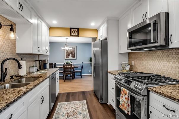 Chandelier, Dining room, Interior, Kitchen, Pendant Lights, Recessed Lighting, Stainless Steel Appliances, Wood Texture Flooring