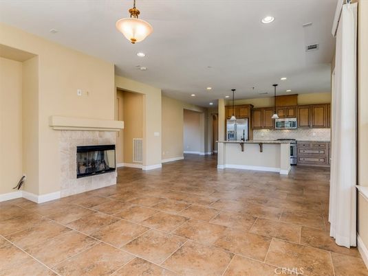 Empty room, Fireplace, Interior, Kitchen, Pendant Lights, Recessed Lighting, Stainless Steel Appliances