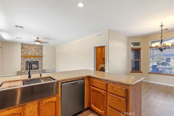 Chandelier, Fireplace, Interior, Kitchen, Recessed Lighting, Stone Walls, Wood Texture Flooring