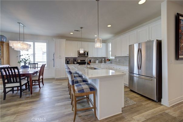 Chandelier, Dining room, Interior, Kitchen, Pendant Lights, Recessed Lighting, Stainless Steel Appliances, Wood Texture Flooring