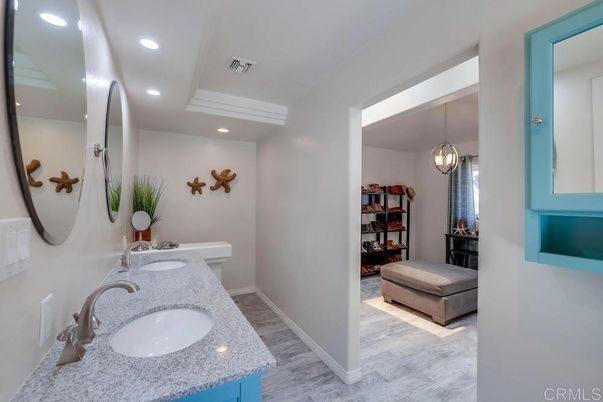 Bathroom, Dual Sink Vanities, Interior, Marble, Pendant Lights, Recessed Lighting, Wood Texture Flooring