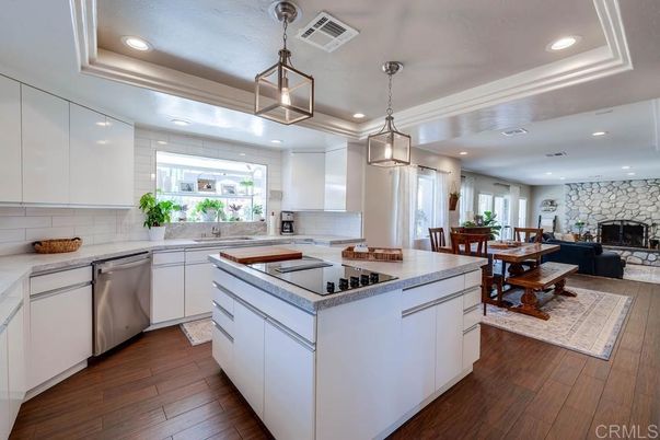 Dining room, Fireplace, Interior, Kitchen, Pendant Lights, Recessed Lighting, Stainless Steel Appliances, Stone Walls, Wood Texture Flooring