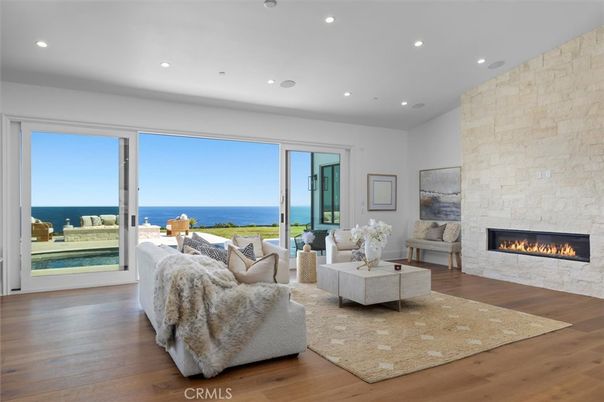 Fireplace, Interior, Living room, Recessed Lighting, Stone Walls, Water, Wood Texture Flooring