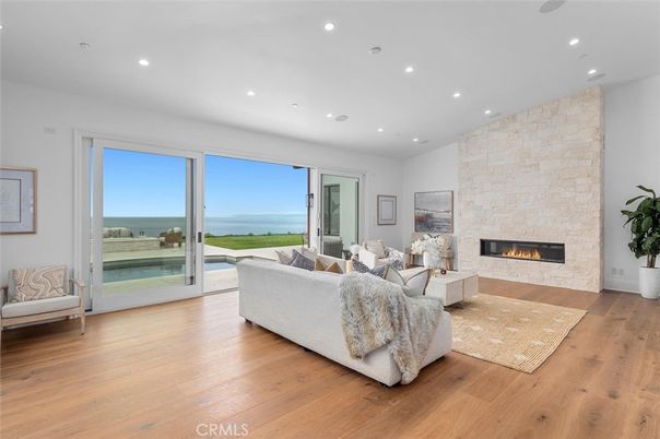 Fireplace, Interior, Living room, Recessed Lighting, Stone Walls, Water, Wood Texture Flooring