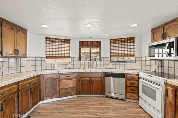 Interior, Kitchen, Recessed Lighting, Tile Countertops, Wood Texture Flooring