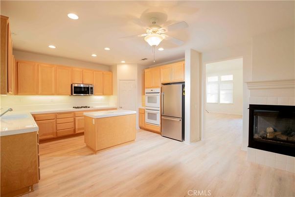 Fireplace, Interior, Kitchen, Recessed Lighting, Stainless Steel Appliances, Wood Texture Flooring