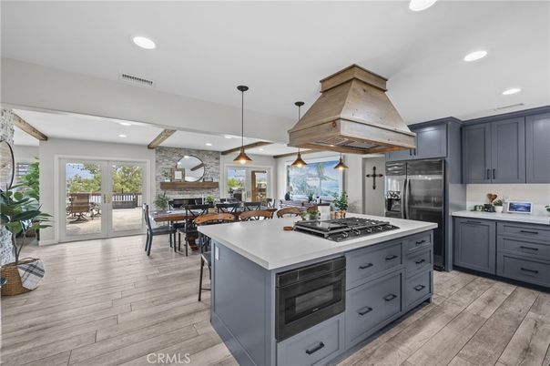 Dining room, Fireplace, Interior, Kitchen, Pendant Lights, Recessed Lighting, Stainless Steel Appliances, Stone Walls, Wood Texture Flooring