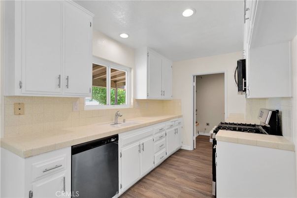 Interior, Kitchen, Recessed Lighting, Tile Countertops, Wood Texture Flooring