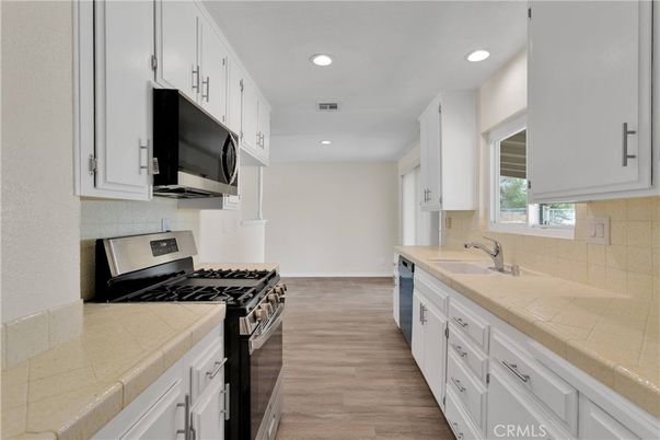 Interior, Kitchen, Recessed Lighting, Tile Countertops, Wood Texture Flooring