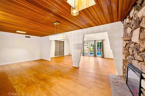 Chandelier, Empty room, Fireplace, Interior, Recessed Lighting, Stone Walls, Wooden Ceilings, Wood Texture Flooring