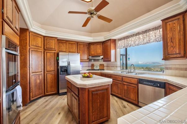 Interior, Kitchen, Stainless Steel Appliances, Tile Countertops, Water, Wood Texture Flooring
