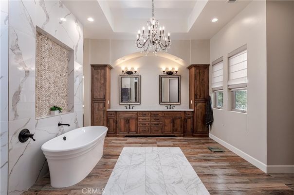 Bathroom, Chandelier, Dual Sink Vanities, Free Standing Baths, Interior, Marble, Marble Walls, Recessed Lighting, Wood Texture Flooring