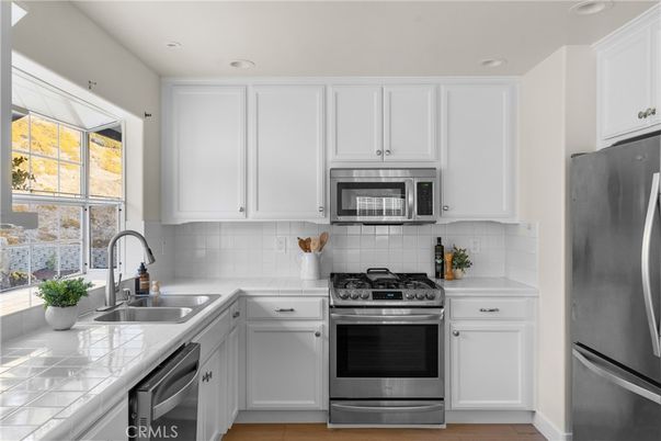 Interior, Kitchen, Recessed Lighting, Stainless Steel Appliances, Tile Countertops, Wood Texture Flooring
