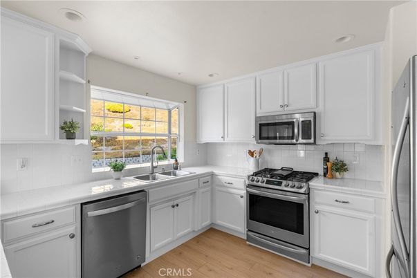 Interior, Kitchen, Recessed Lighting, Stainless Steel Appliances, Tile Countertops, Wood Texture Flooring