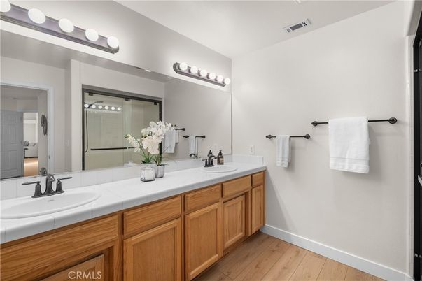 Bathroom, Dual Sink Vanities, Glass Shower, Interior, Tile Countertops, Wood Texture Flooring
