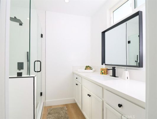 Bathroom, Dual Sink Vanities, Glass Shower, Interior, Recessed Lighting, Wood Texture Flooring