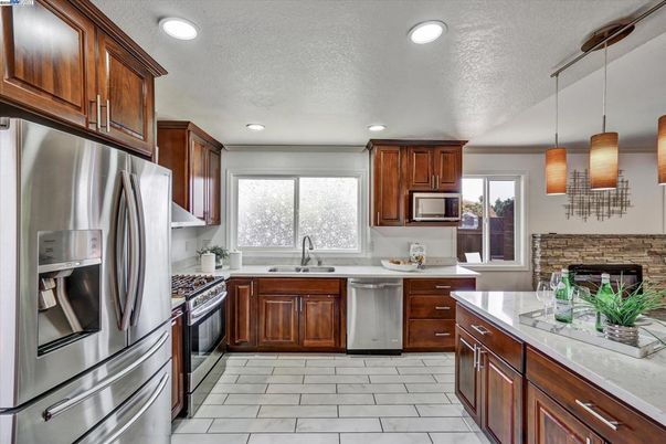 Fireplace, Interior, Kitchen, Pendant Lights, Recessed Lighting, Stainless Steel Appliances, Stone Walls