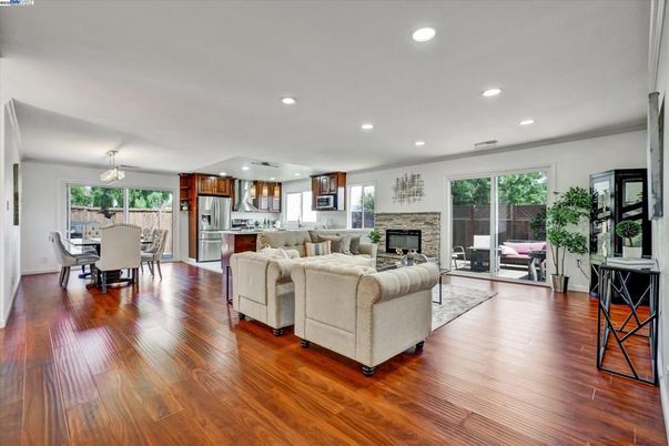 Dining room, Fireplace, Interior, Kitchen, Living room, Recessed Lighting, Stainless Steel Appliances, Wood Texture Flooring