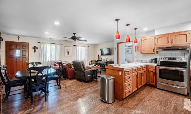 Dining room, Interior, Kitchen, Living room, Pendant Lights, Recessed Lighting, Stainless Steel Appliances, Tile Countertops, Wood Texture Flooring