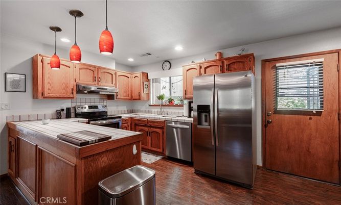Interior, Kitchen, Pendant Lights, Recessed Lighting, Stainless Steel Appliances, Tile Countertops, Wood Texture Flooring