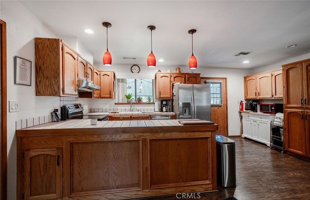 Interior, Kitchen, Pendant Lights, Recessed Lighting, Tile Countertops, Washer, Wood Texture Flooring