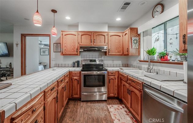 Interior, Kitchen, Pendant Lights, Recessed Lighting, Stainless Steel Appliances, Tile Countertops, Wood Texture Flooring
