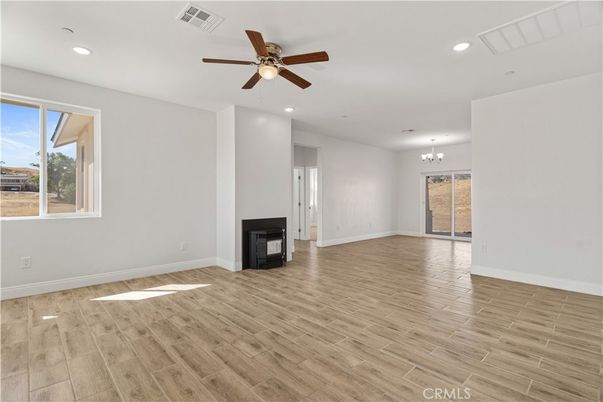 Chandelier, Empty room, Fireplace, Interior, Recessed Lighting, Wood Texture Flooring
