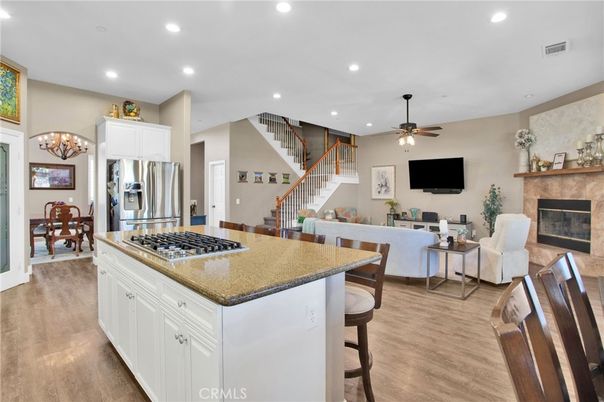Chandelier, Dining room, Fireplace, Interior, Kitchen, Living room, Recessed Lighting, Stainless Steel Appliances, Wood Texture Flooring