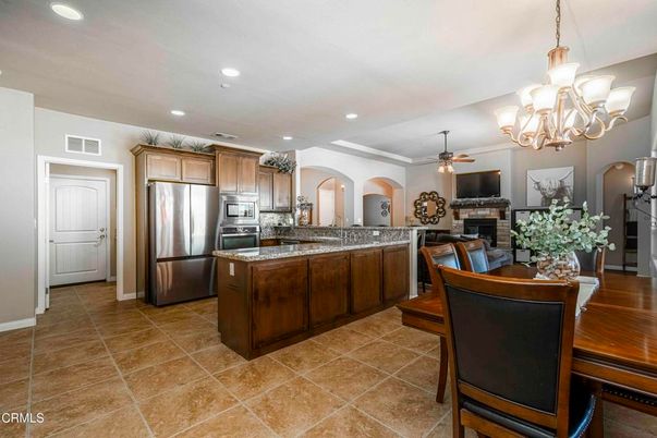 Chandelier, Dining room, Fireplace, Interior, Kitchen, Recessed Lighting, Stainless Steel Appliances
