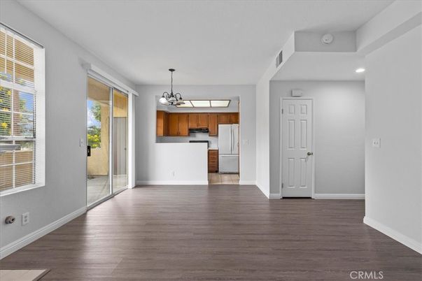 Chandelier, Empty room, Interior, Kitchen, Pendant Lights, Recessed Lighting, Stainless Steel Appliances, Wood Texture Flooring