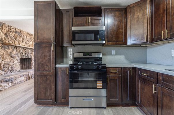 Fireplace, Interior, Kitchen, Stainless Steel Appliances, Wood Texture Flooring