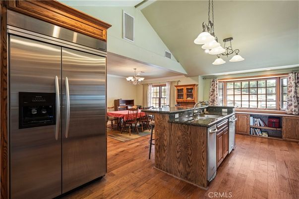 Chandelier, Dining room, Interior, Kitchen, Pendant Lights, Stainless Steel Appliances, Wood Texture Flooring