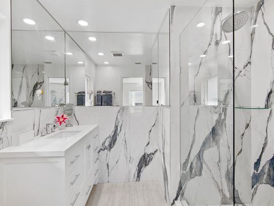 Bathroom, Dual Sink Vanities, Glass Shower, Interior, Marble Walls, Recessed Lighting, Wood Texture Flooring
